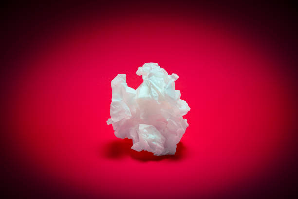 istock Crumpled white paper texture on pink background 1126664290