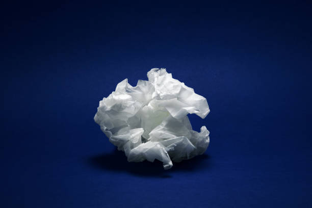 istock Crumpled white paper texture on dark blue background 1126664377