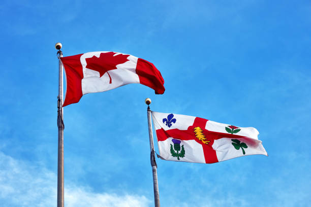 istock Canada flag and Montreal flag waving on clear blue sky background 1126666084
