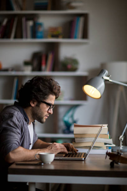 istock Man hands typing on a laptop keyboard on a desk 1126667799
