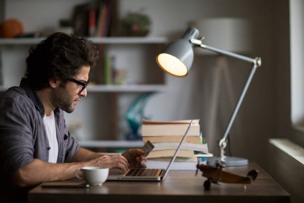 istock Man is shopping online with laptop 1126667899