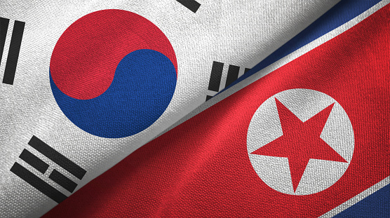 North Korea and South Korea flags together textile cloth, fabric texture