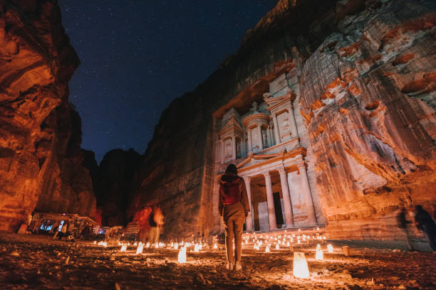 istock Woman looking at Petra by night 1126671105