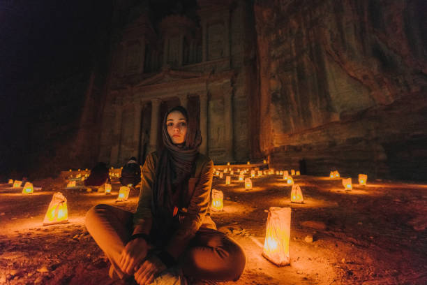 istock Woman looking at Petra by night 1126671152