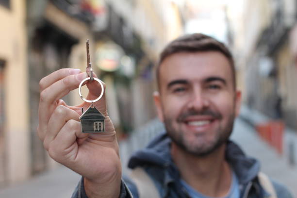 istock Young man holding house keys 1126672093