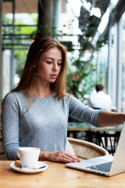 istock a pretty woman behind her laptop 1126673183
