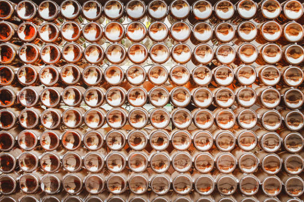 istock Bottoms of brown beer bottles group patterns texture on wall abstract for background 1126676943