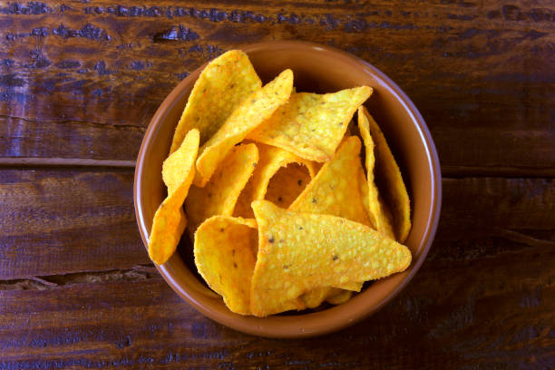 istock Nachos corn chips placed in ceramic bowl on wooden table, copy space 1126678606