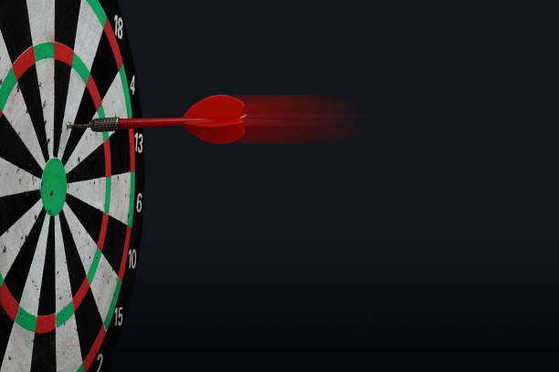 istock Dart arrow hitting on center target of dartboard. 1126679860