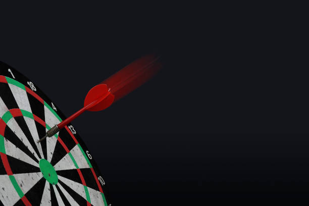 istock Dart arrow hitting on center target of dartboard. 1126679930