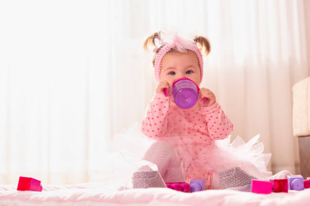 istock Baby girl drinking water from a bottle 1126680500