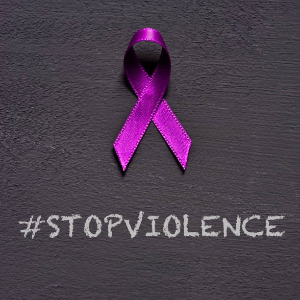 istock purple ribbon and text stop violence 1126680787