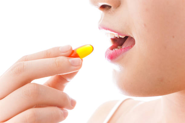 istock Young woman taking medicine 1126688220