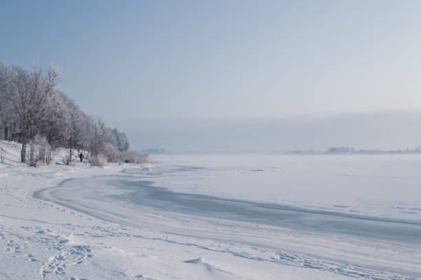 istock Cold sunny frozen day view by the river in winter 1126693035