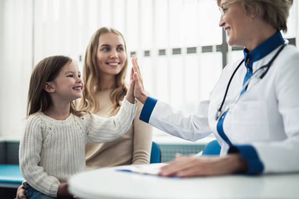 mother and her daughter consulting with doctor - medicine cabinet medicine healthcare and medicine cabinet imagens e fotografias de stock