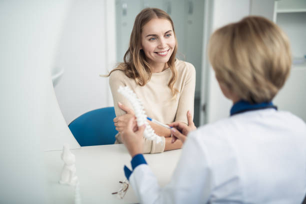 Medical consultation of woman by doctor in clinic stock photo
