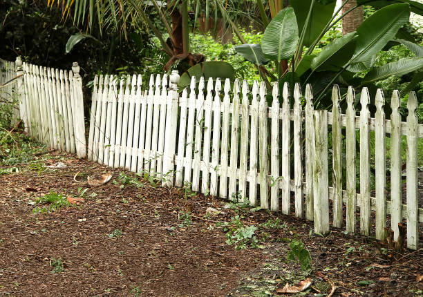 broken and neglected picket fence stock photo