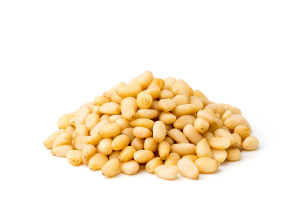 istock Heap of pine nuts on a white, closeup. 1126695130