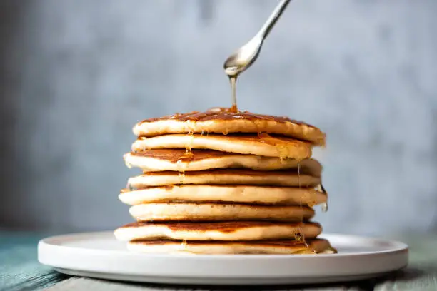 Stack of pancakes with honey. Tasty breakfast.