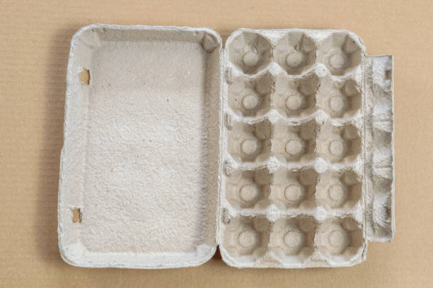 istock Top view of cardboard egg container on a brown background 1126697440
