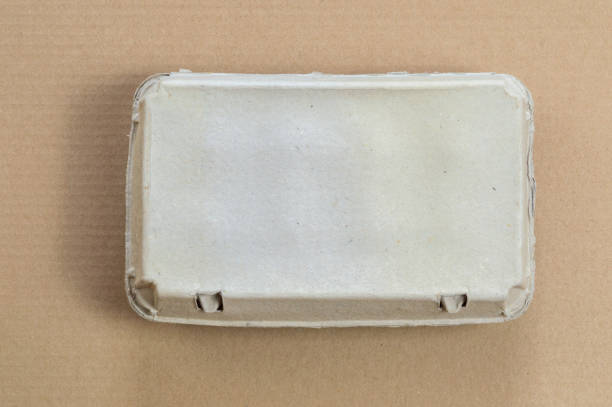 Top view of cardboard egg container on a brown background