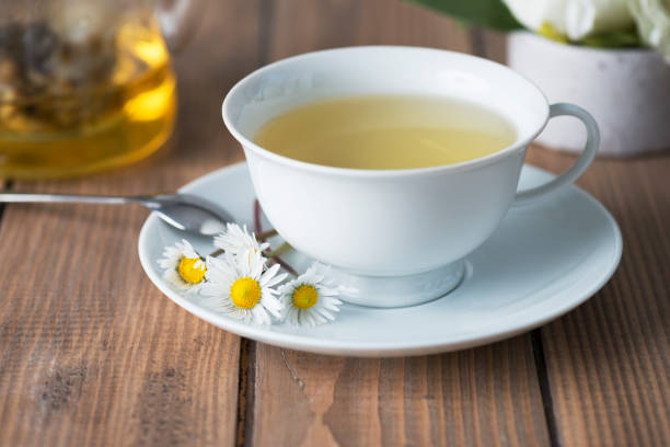 Herbal Tea Herbal tea on wooden table with chamomile plants. chamomile photos stock pictures, royalty-free photos & images