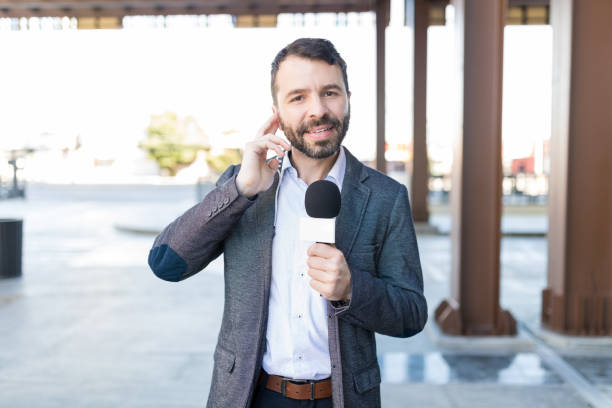 istock Attractive Correspondent Taking Interview Outdoors 1126700491