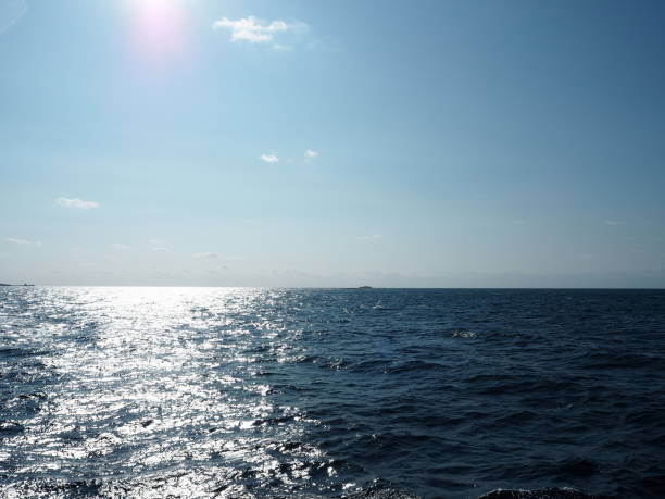 istock Shining sun and its sparkling reflection on the sea surface 1126703219