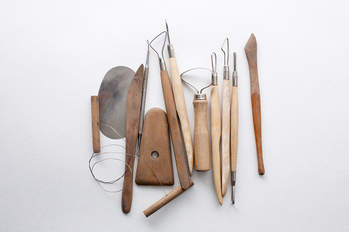 composition of tools for sculptors on white background