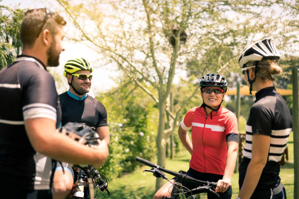 Male and female cyclists with bicycles in yard