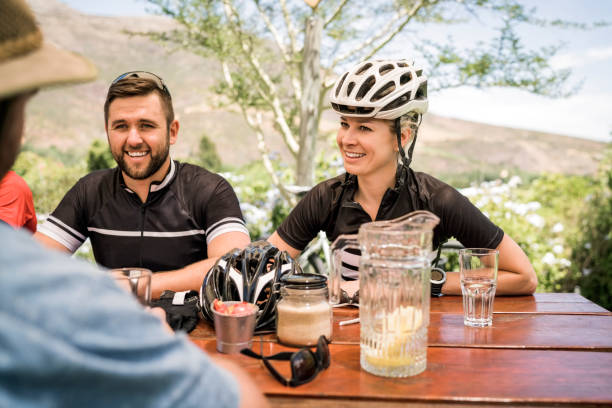 istock Happy cyclists looking at man in yard 1126705793