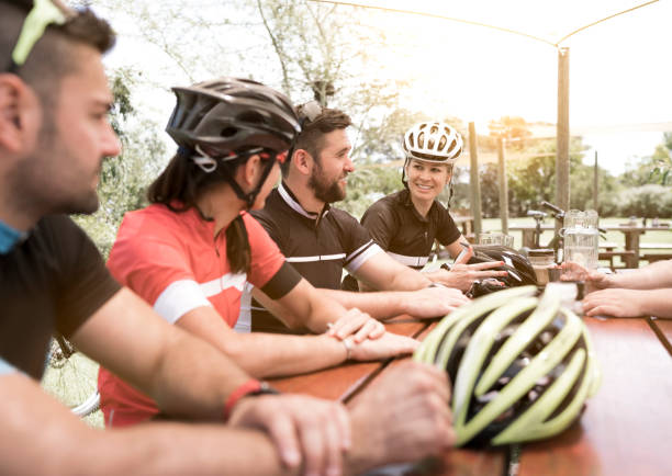 istock Smiling male and female cyclists talking in yard 1126705864