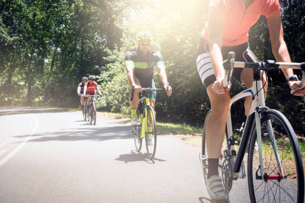 istock Cyclists riding bicycles on road during summer 1126706752