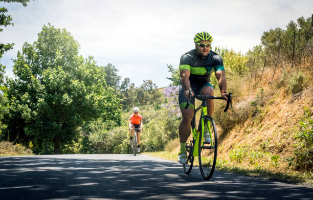 Determined cyclist riding bicycle on country road