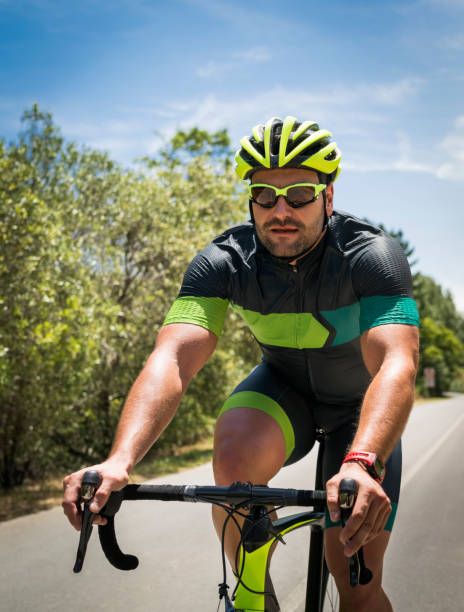 istock Determined cyclist riding bicycle on country road 1126707032