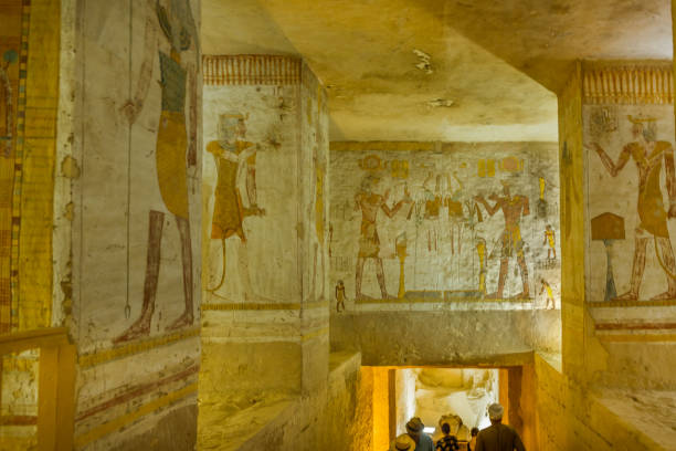 tourists visit a tomb with wall-paintings in the valley of the kings stock photo