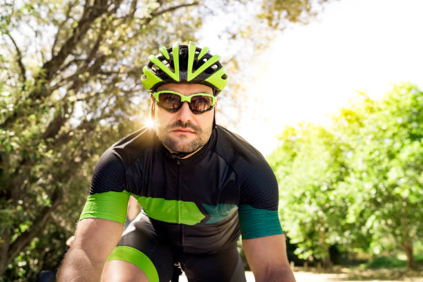 istock Determined male cyclist riding bicycle in forest 1126707295