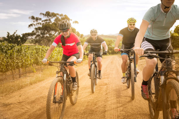 istock Cyclists riding bicycles on dirt road 1126707298
