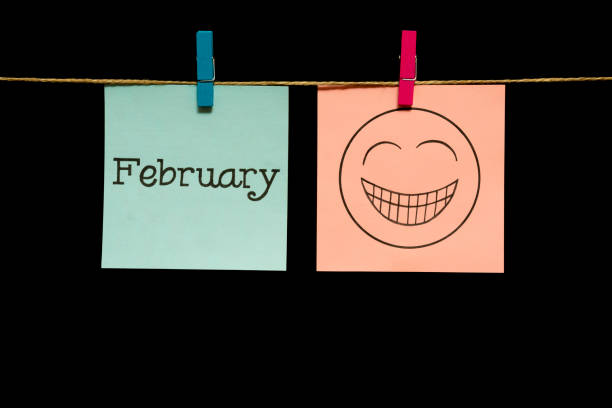 istock Emotion. Two multicolored stickers. On the left sheet inscription February. On the right white page an expression of festive mood. 1126707424