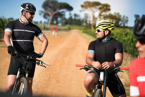 istock Male cyclists talking on dirt road 1126707448