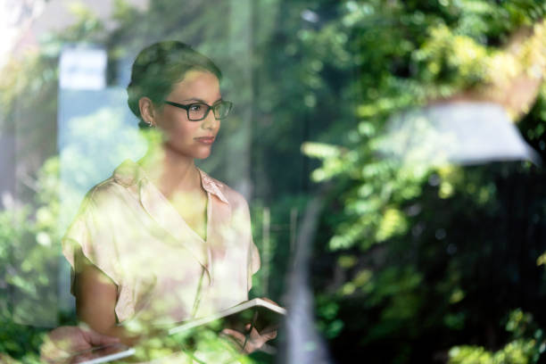 istock Thoughtful businesswoman holding diary in office 1126707526