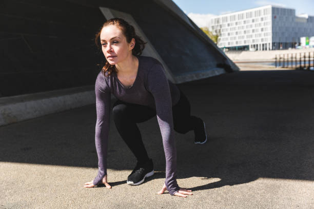 istock Woman doing stretching exercises in the city 1126709718