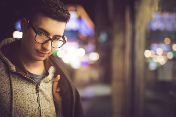 Downtown portrait Young man portrait downtown window shopping at night stock pictures, royalty-free photos & images