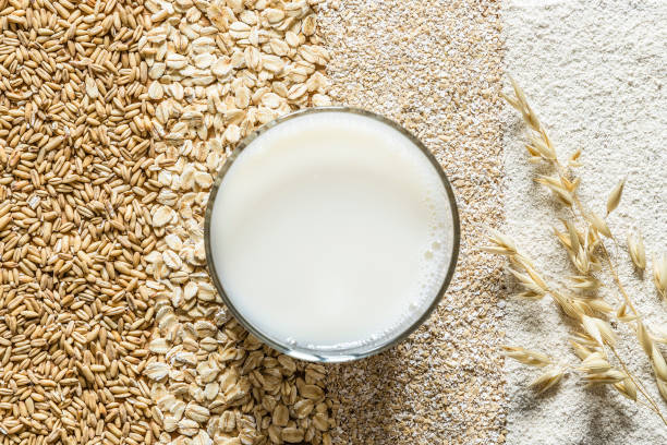 Oat grain, oat flakes, oat bran, oat flour and oat milk background. stock photo