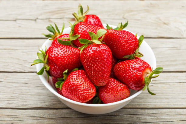 istock Fresh ripe strawberries in a simple white bowl 1126713237
