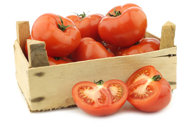 istock fresh beef tomatoes and a cut one in a wooden crate 1126714669