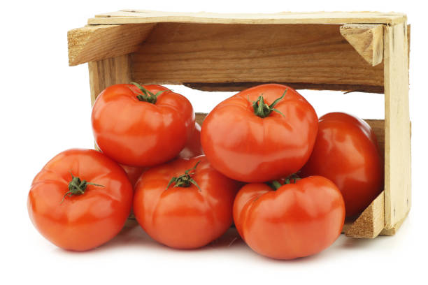 istock fresh beef tomatoes in a wooden crate 1126714706