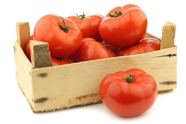 istock fresh beef tomatoes in a wooden crate 1126714760
