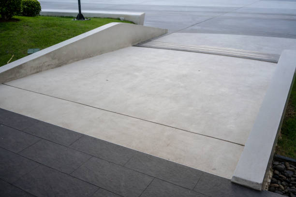 istock Wide ramped access, using wheelchair ramp for disabled people. Concrete ramp pathway. 1126716916