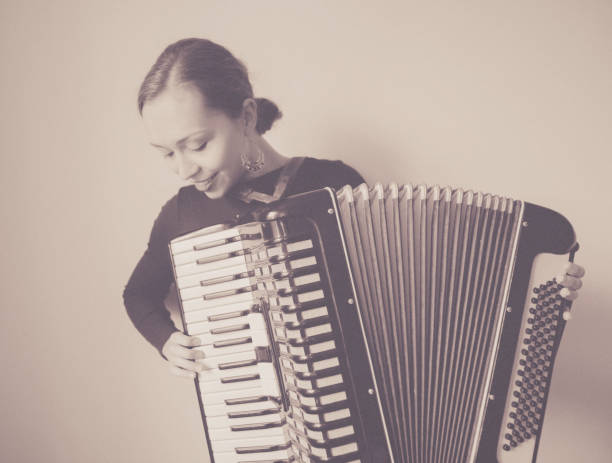 istock Young Woman with old Accordion 1126718329